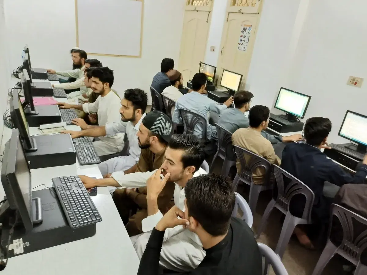 Students learning and practicing at computers in the CBA academy lab